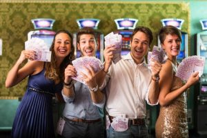Happy people with money from casino